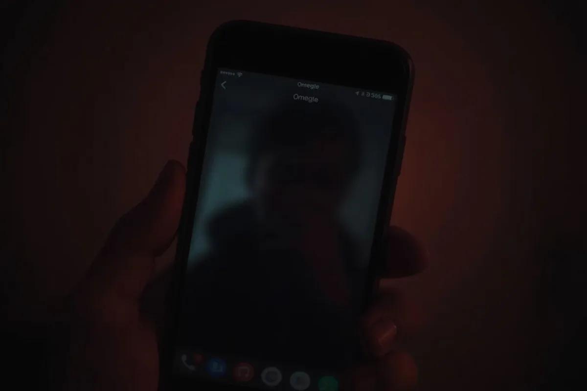 Blurred Omegle chat interface on a smartphone screen